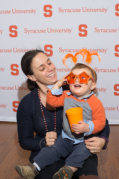 Lindsay Damon G'08 visits the photo booth with her son