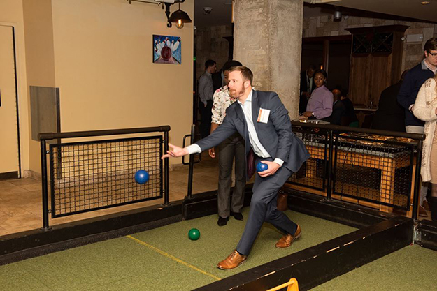 A party guest enjoys playing bocce.