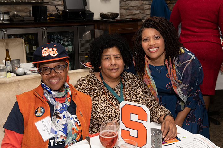 Rachel Vassel ’91 (right) with guests at the holiday celebration