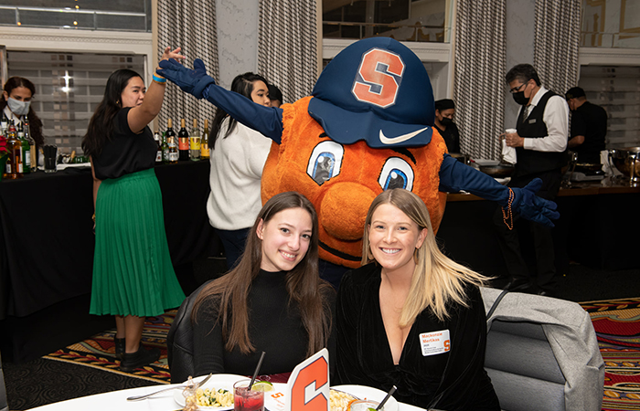 Otto visits guests at their table.